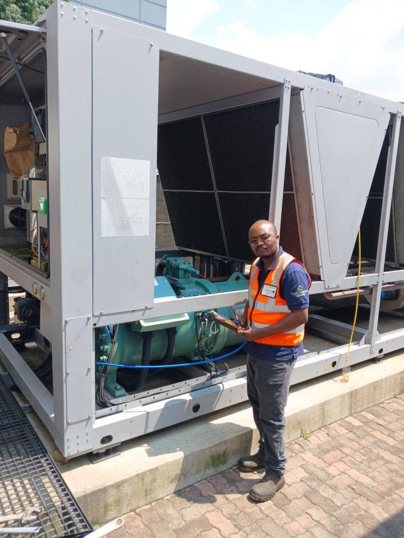 HVAC Technologies technician testing an air-cooled chiller with gauges