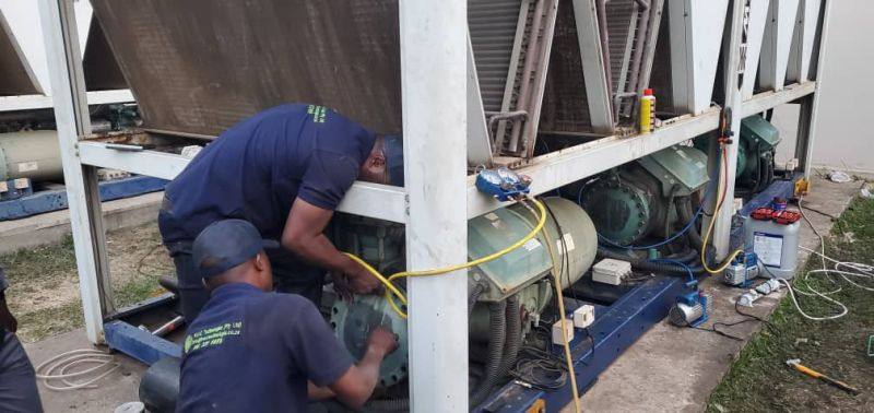 Two technicians servicing an air-cooled chiller