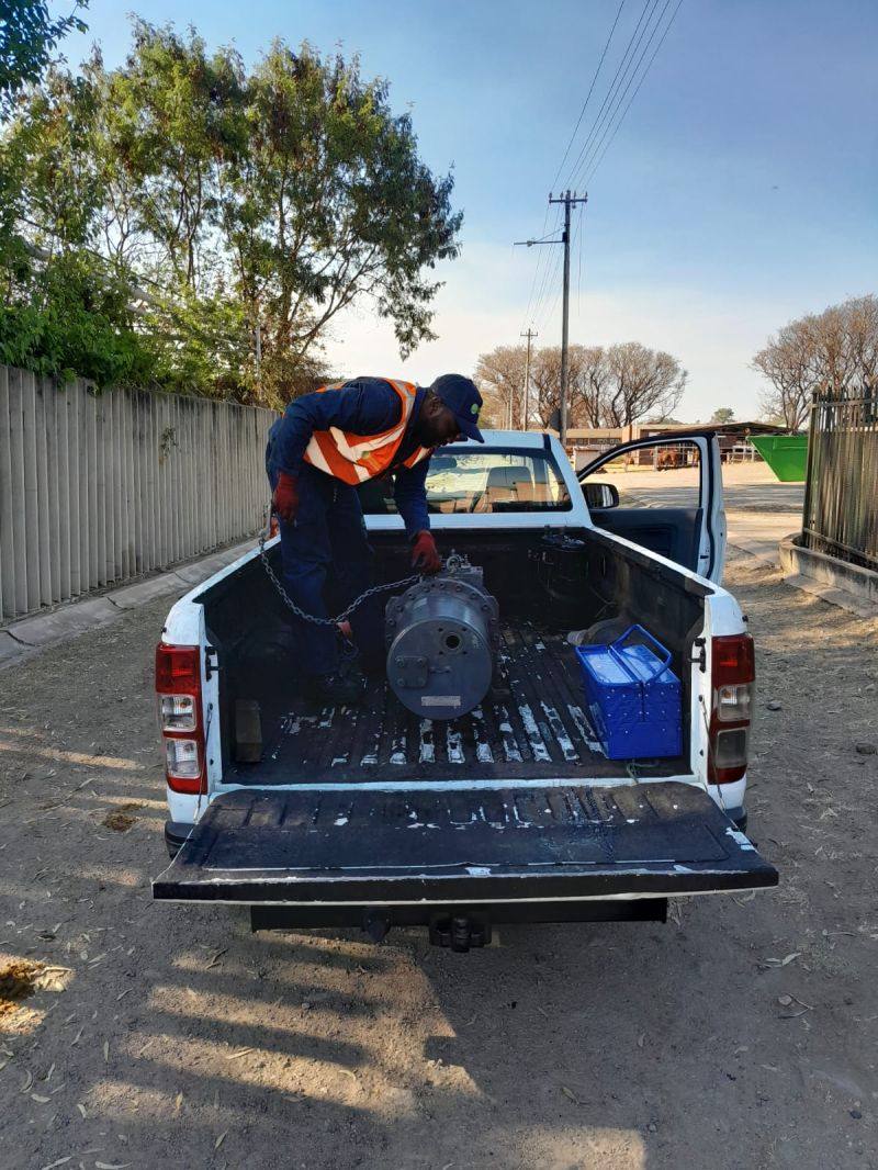 Technician loading a compressor unit for site delivery