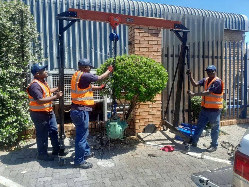 HVAC Technologies crew rigging a compressor on site