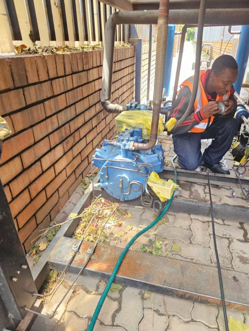 Technician servicing an outdoor temperature drop unit